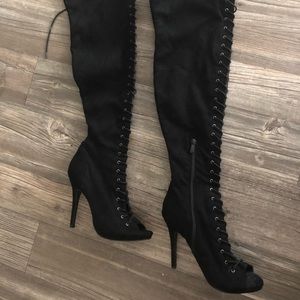 Black thigh-high lace up boots